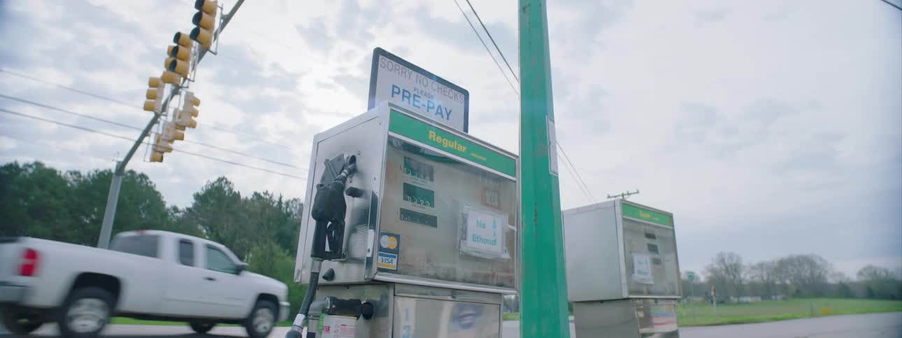 A pair of old gas pumps at a gas station