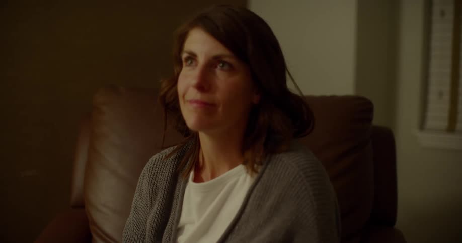 A woman sitting up from a laid back position in her chair