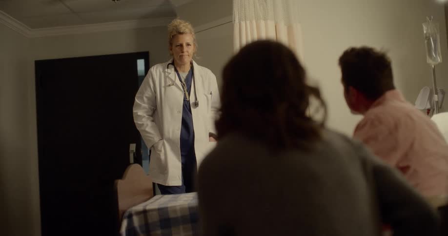 A doctor comes into a room in a hospital