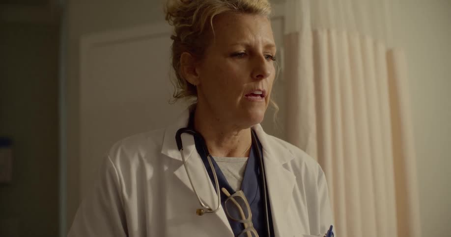 A doctor stands and talks to someone