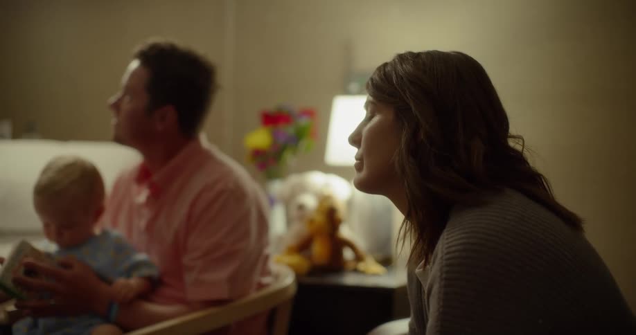 A family sits in a hospital room and listens to someone