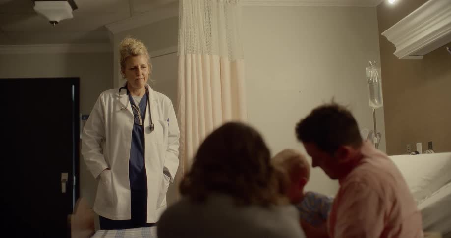 A doctor talks to a family in a hospital room