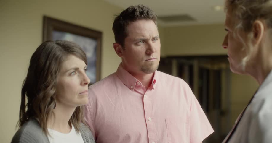 A doctor talking to a man and a woman