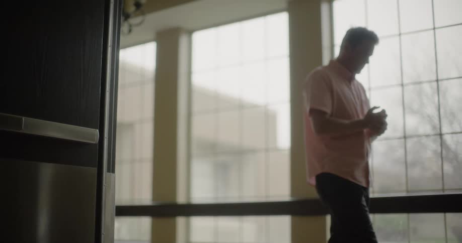 Man walks along the hospital hallway