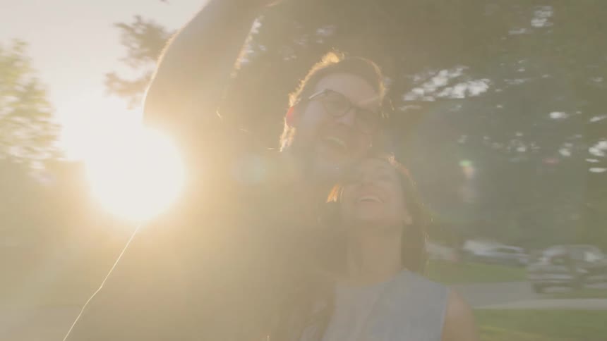 Couple face timing on a smartphone outdoor in early morning