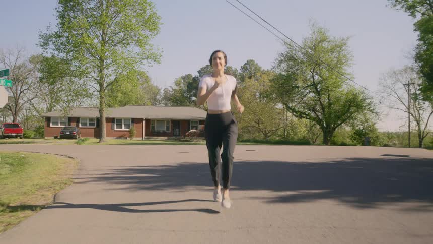 A woman runs a long a quiet street