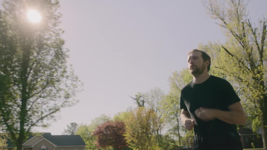 Man jogging in neighborhood in early morning