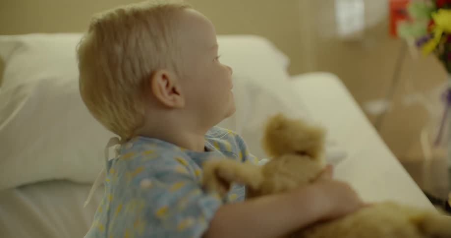 A person is playing with their son in the hospital