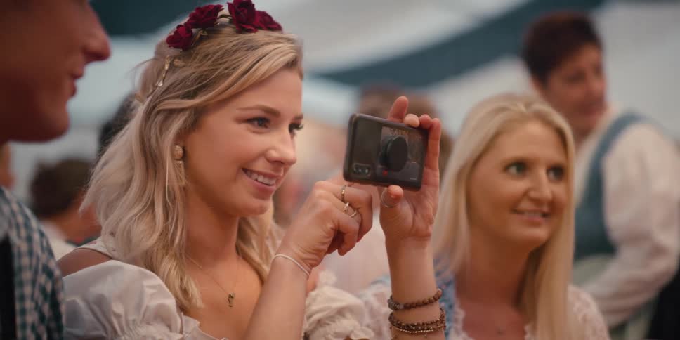 A woman taking a photo with her camera at a celebration
