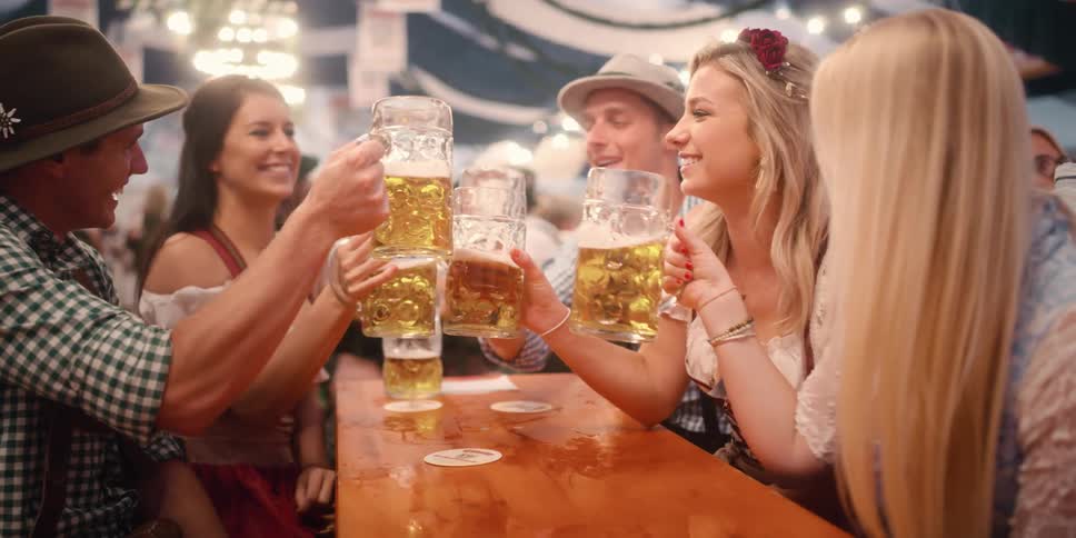 A group of friends are at a bar and drinking beer