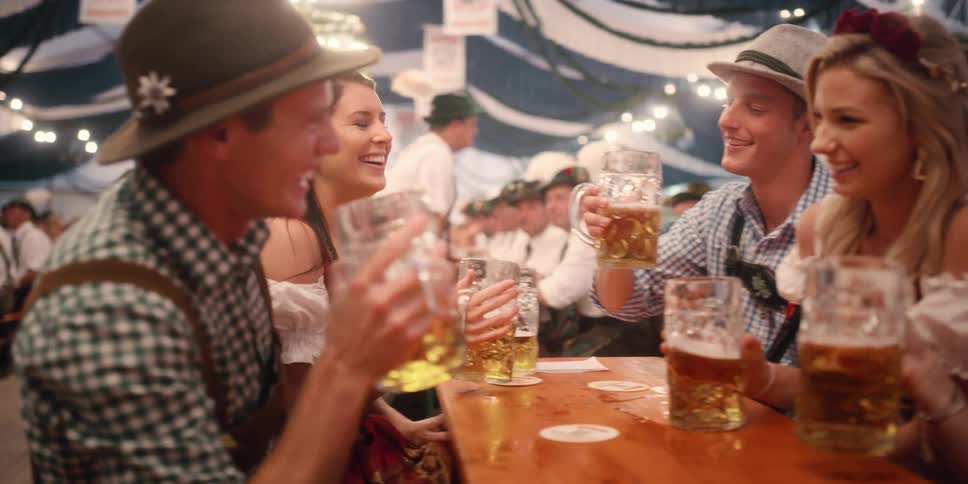Groups of people have drinks together at tables