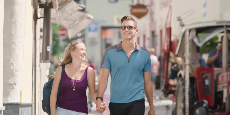 A man and a woman walking down a street