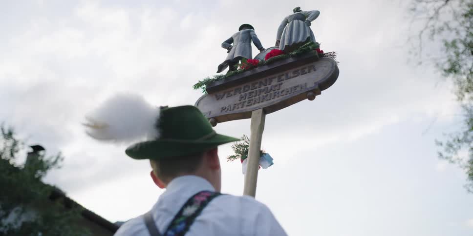 A man carrying a sign walks in a parade