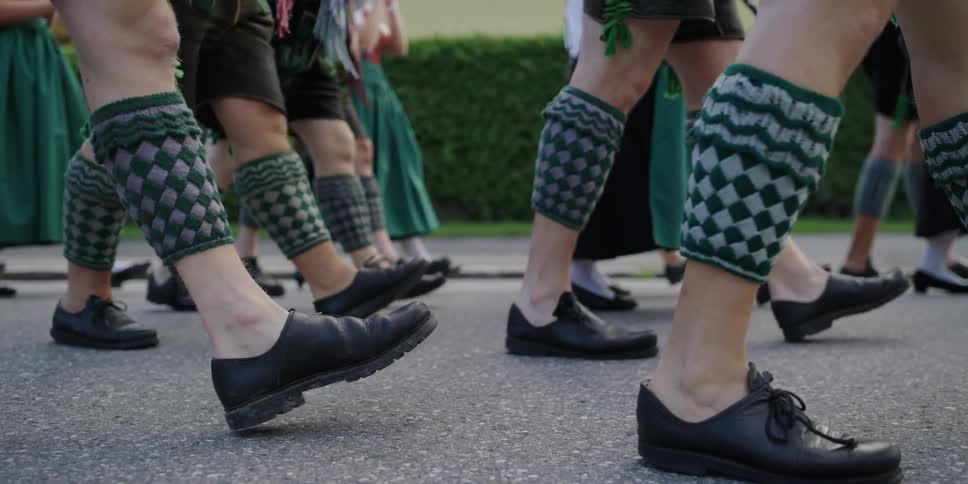 People wearing traditional swiss clothes on parade at day