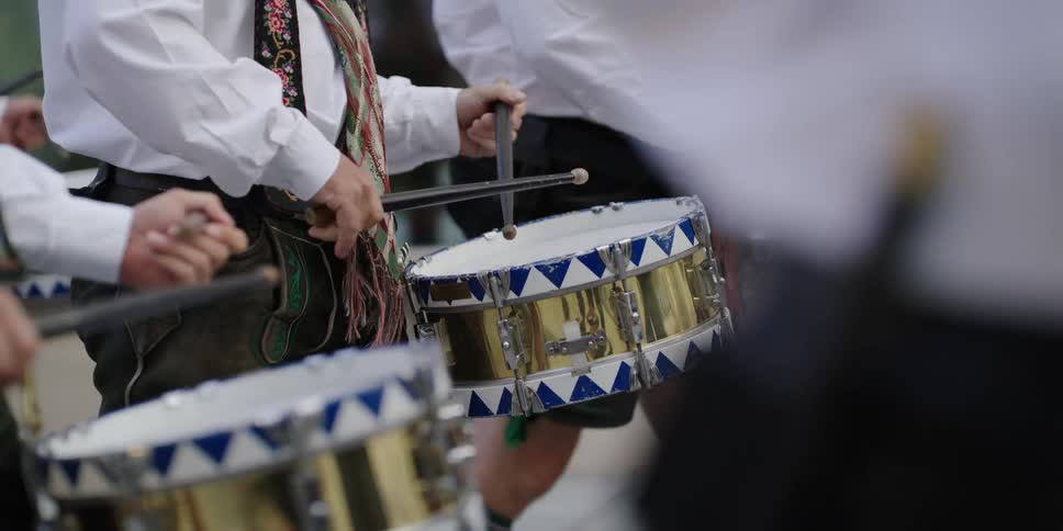Drummers marching in oktoberfest event wearing german costume