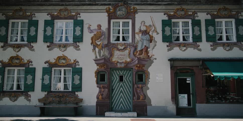 The elaborate green and white facade of building during the day