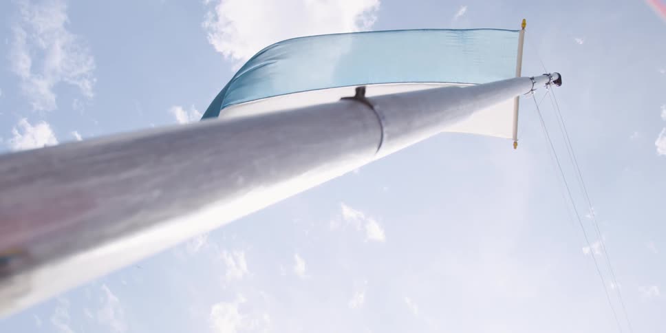 I long pole with a blue and white flag attached to the pole
