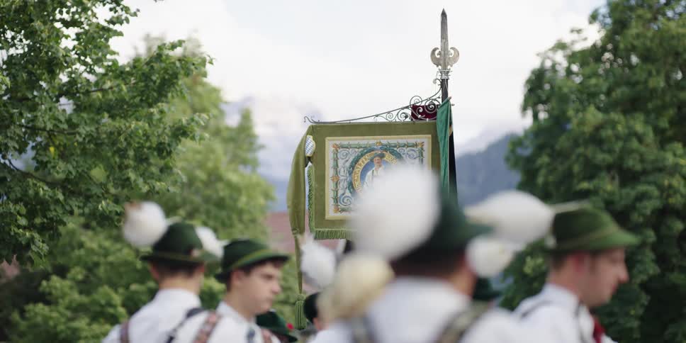 Men stand around near the mountains