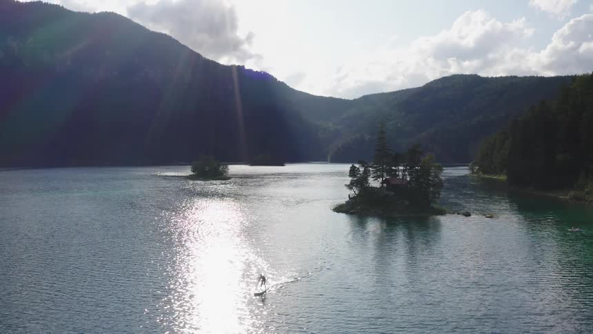 A person stands on a board in the water