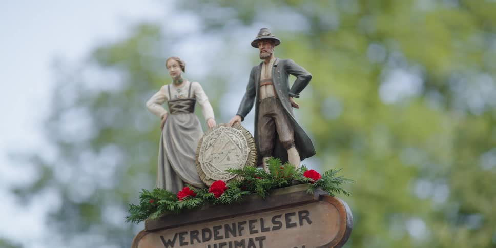 A decoration atop a wobbling sign