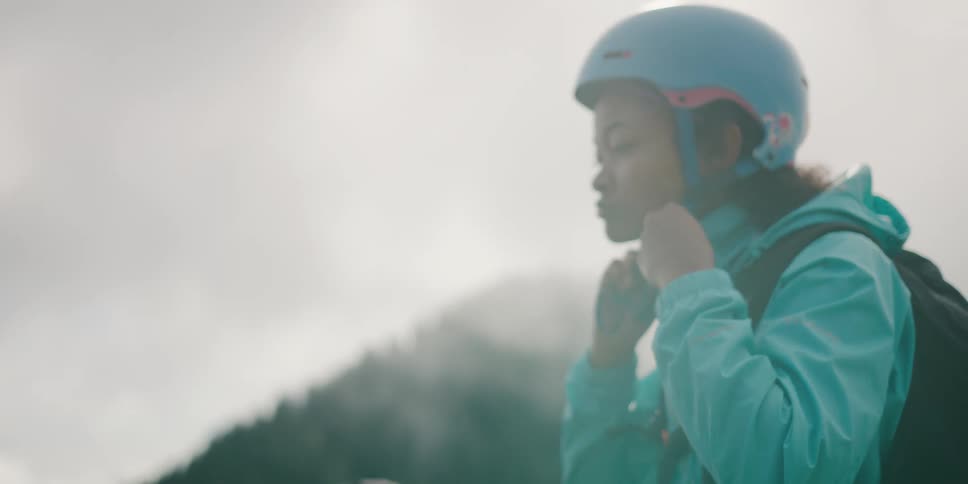 A woman puts on a helmet