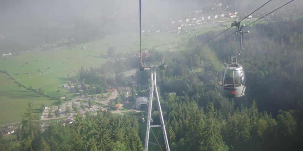 A gondola lift travels down the mountain