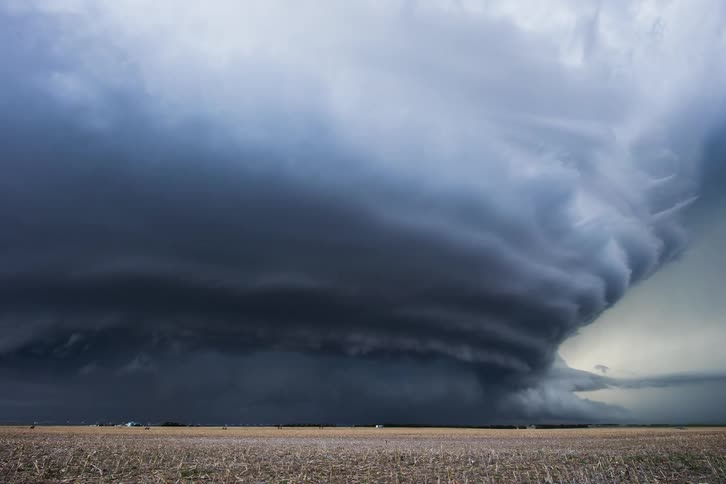 Storm clouds releasing rain over plains