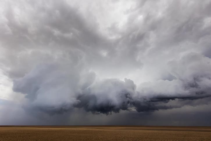 Dark storm clouds gather over the dry plains