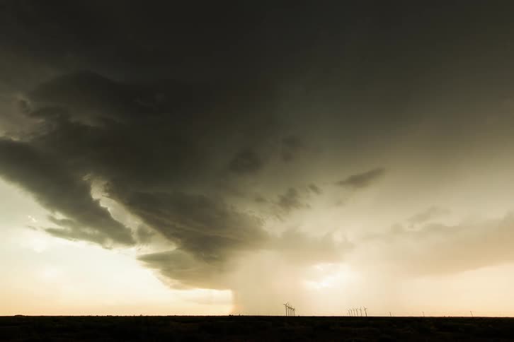 Thunder clouds forming of a field of wind turbines