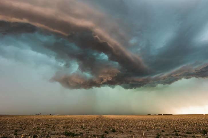 Timelapse of storm clouds releasing rain on plains at sunset