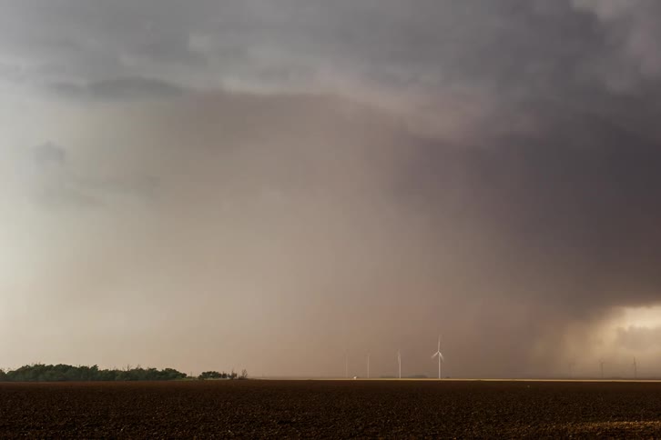 Swirling thunderclouds over a field of wind turbines