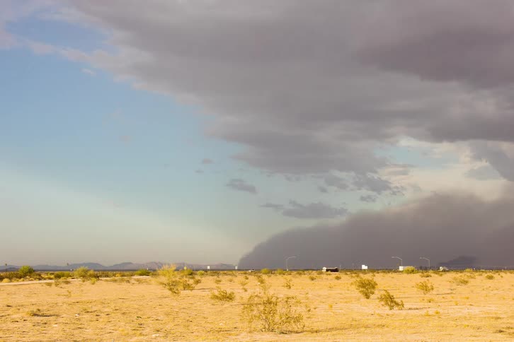 A wall of dust moving across the desert