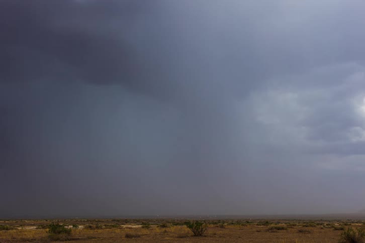 Storm clouds gathering over desert plains at day