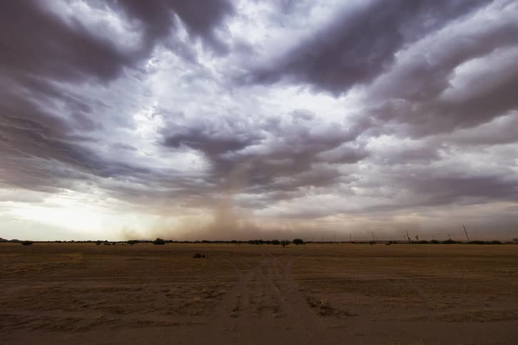 The wind blows the sand across the desert