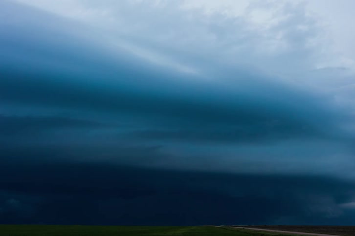 Timelapse of storm clouds releasing rain over plains at sunset