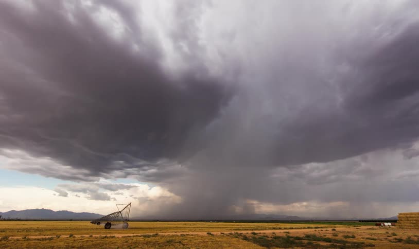 Storm clouds bring rain to a farmers field