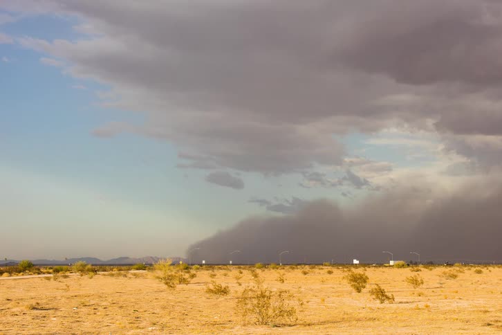 A wall of dust moving across the desert