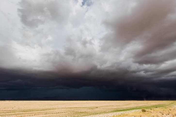 Dark storm clouds gather over the dry plains