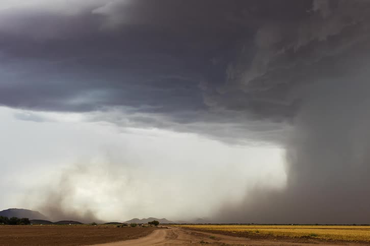 Time lapse of a tornado sweeping across a field in the country
