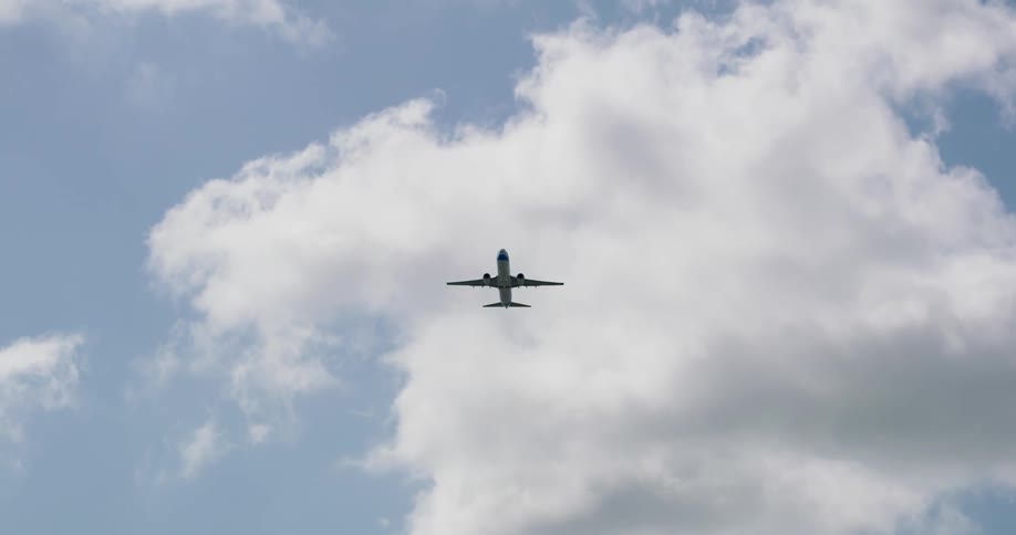 Worms eye view of an airplane flying through the sky