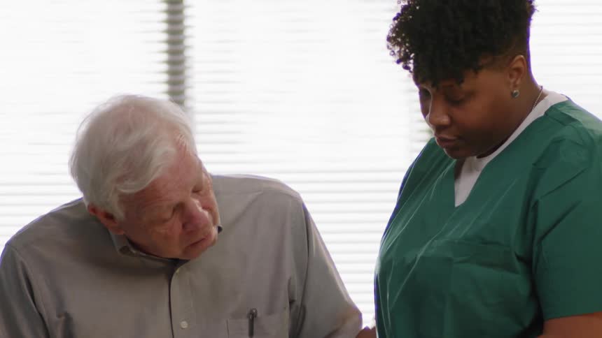 A nurse talks to a patient
