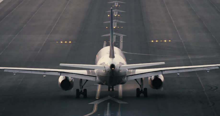Airplane takes off from runway in airport at day