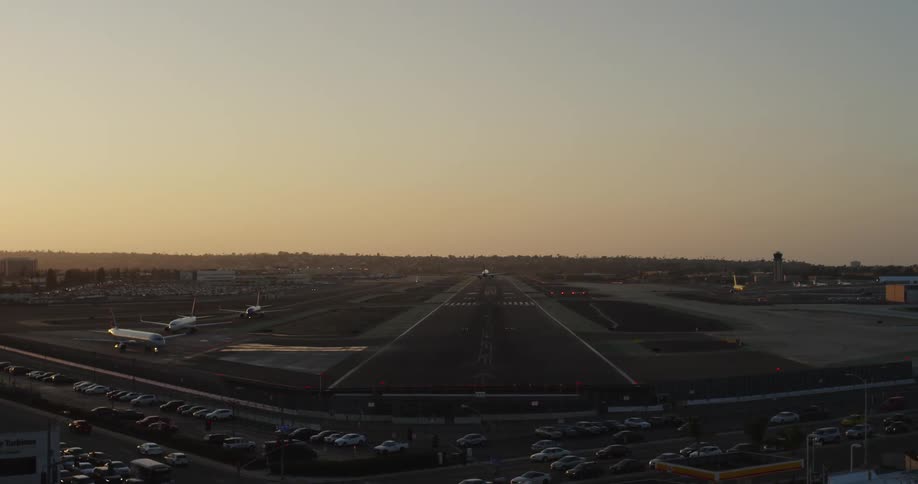 An airplane lands on a landing strip