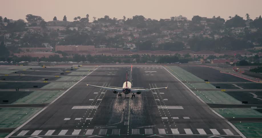 An airplane landing on an airstrip