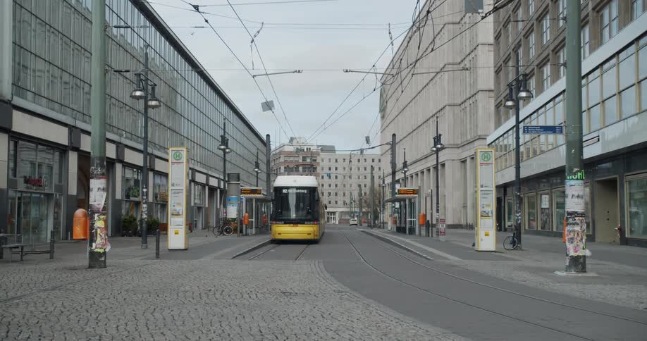 Person disembarks from light rail on city street