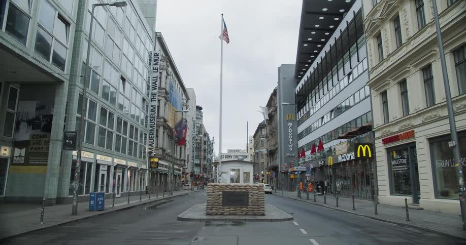 An empty city street lined with restaurants and stores