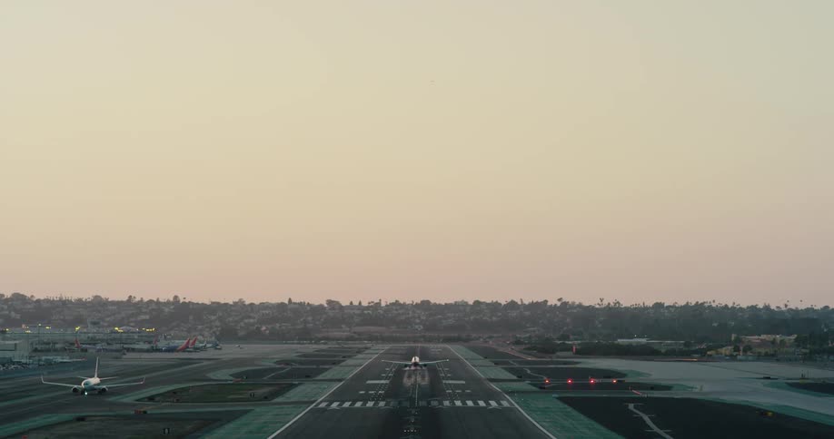 An airplane lands on a runway at an airport