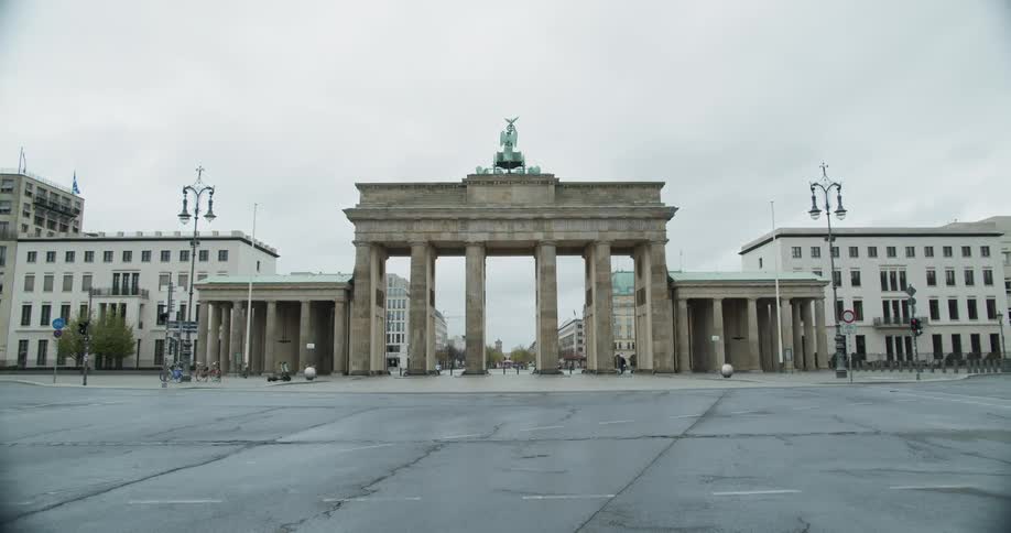 A town square with pillars and buildings in the background