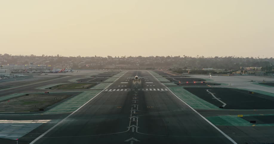 Airplane takes off from airport at sunrise