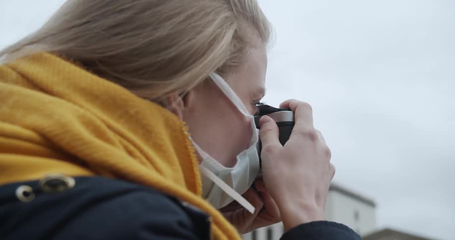 A woman takes a picture with a camera